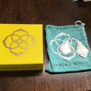 Kendra Scott white earrings, trimmed with silver tone. . Brand new.